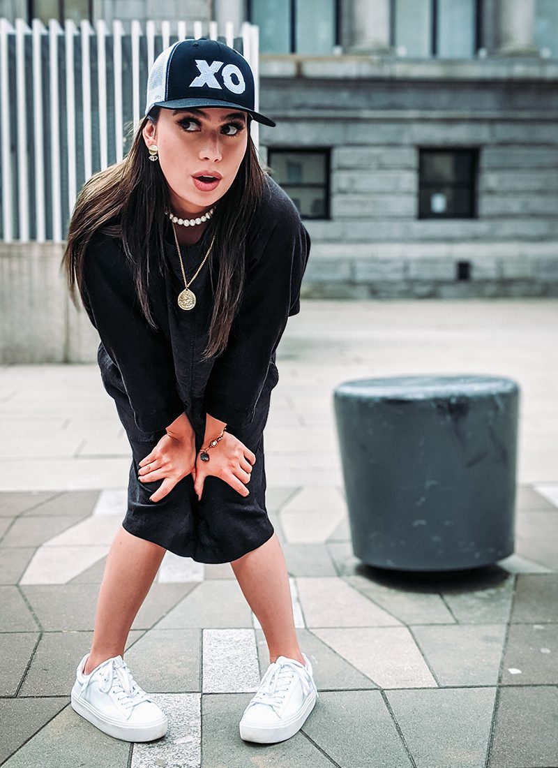 Model Wearing XO Trucker Hat Black and White at Vancouver Art Gallery